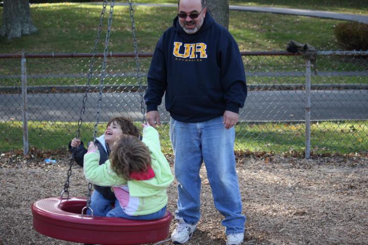 Ian pushes the kids on the tire
