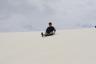 Robert sledding at White Sands
