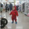 Shopping.  Jonathan tries on slippers in store
