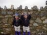 Robert and Jonathan stand by the stone wall