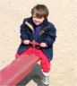 Robert tries the see-saw (by the beach)