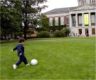 Jonathan kicks a soccer ball on the main quad
