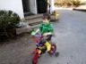Robert rides his bike on the driveway