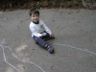 Jonathan draws on the driveway with chalk