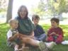 Nancy sits with Che, Robert & Jonathan for a snack in the park