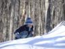 Jonathan climbs a snow covered rock
