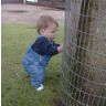 Jonathan squats by a tree